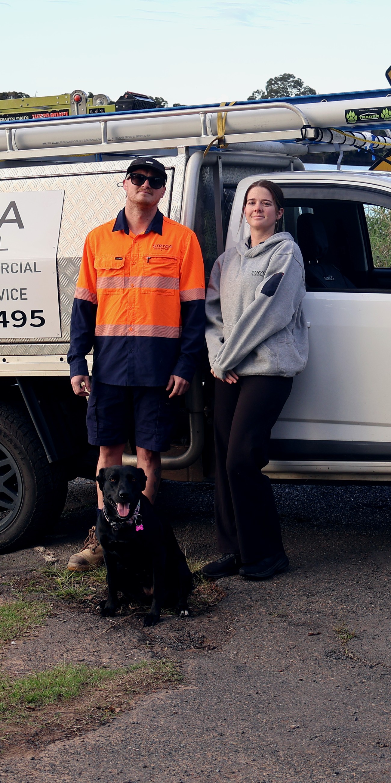Josh and the Stryda Electrical team with Stryda the dog, beside the branded work ute